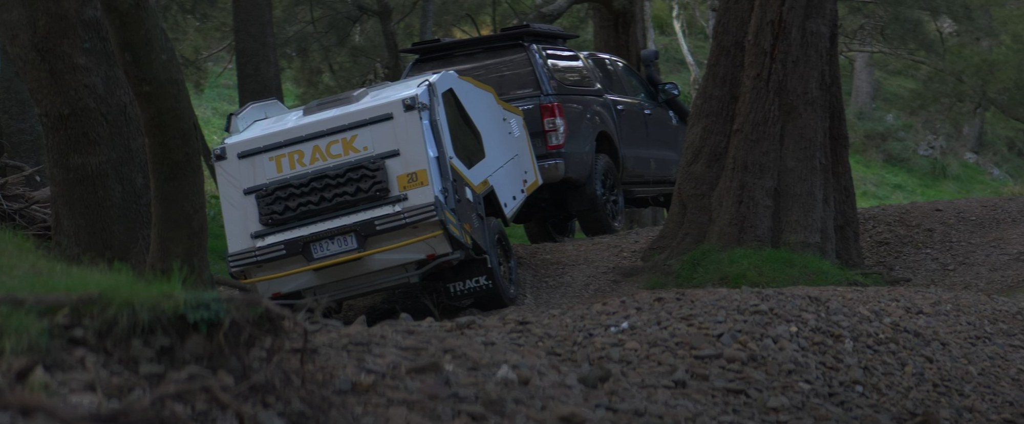 The Track Trailer T-van towed through water on a bush track at dusk