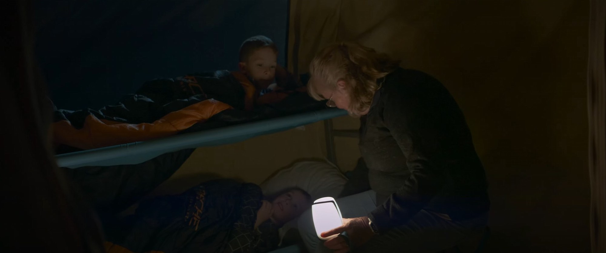 A family beside the T-van at camp